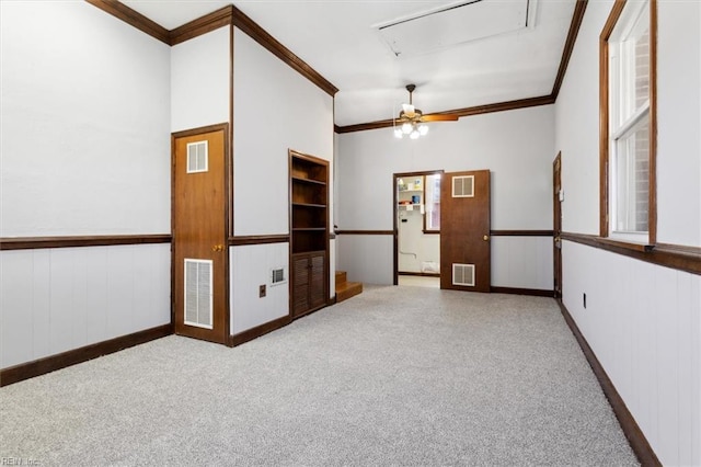 carpeted spare room featuring ornamental molding