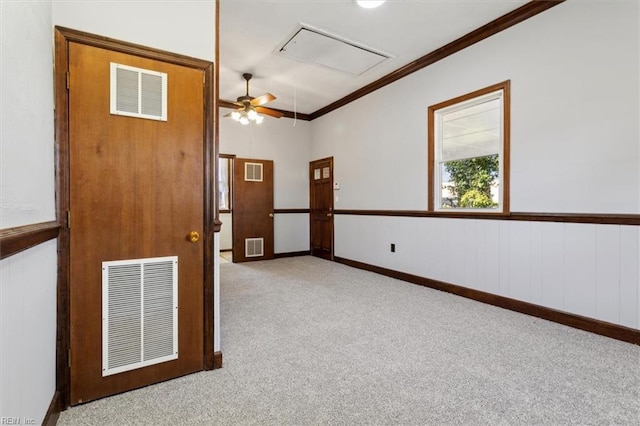 carpeted spare room with ornamental molding and ceiling fan