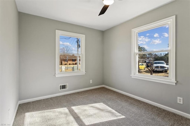 carpeted empty room featuring ceiling fan