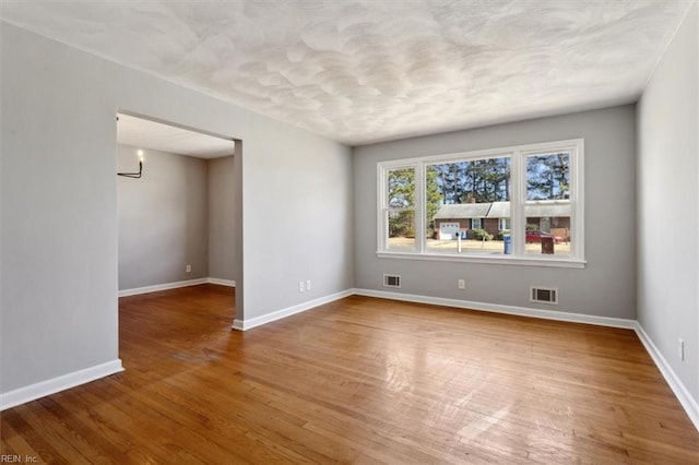 spare room featuring hardwood / wood-style flooring