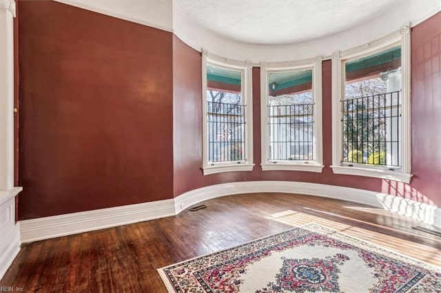 unfurnished room with hardwood / wood-style floors