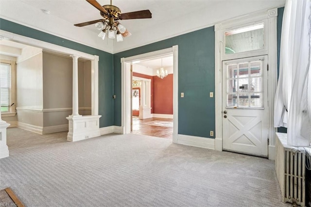 interior space featuring decorative columns, radiator, and ceiling fan