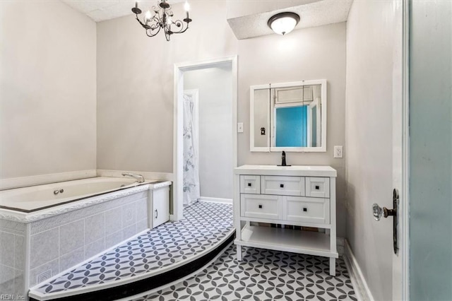 bathroom with vanity, tiled tub, and a notable chandelier