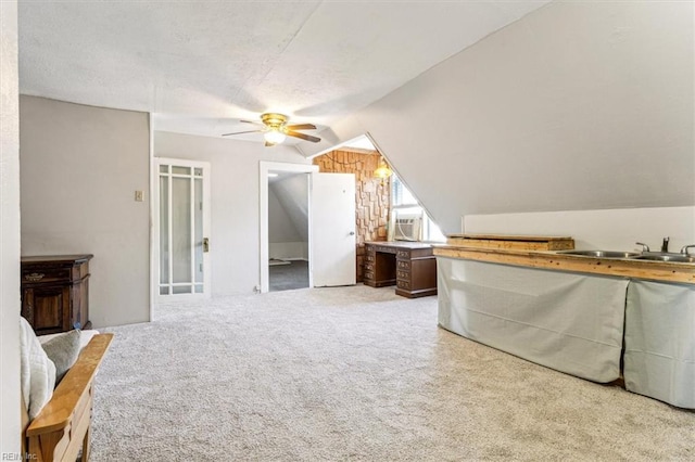 bedroom with lofted ceiling, sink, ceiling fan, cooling unit, and light carpet