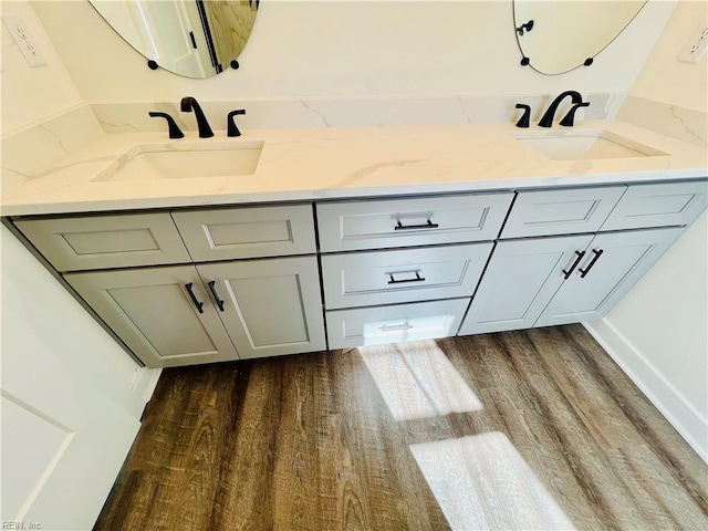 bathroom with vanity and wood-type flooring