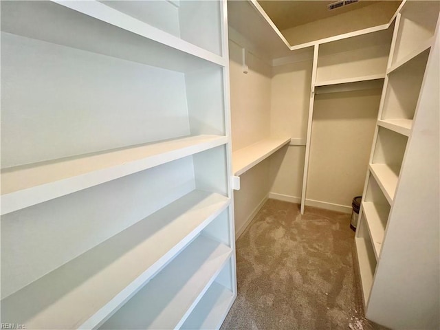 spacious closet with dark carpet