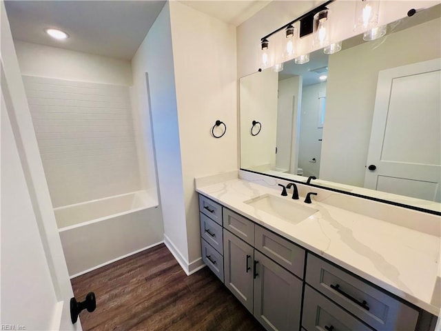 full bathroom featuring wood-type flooring, toilet, shower / bathing tub combination, and vanity