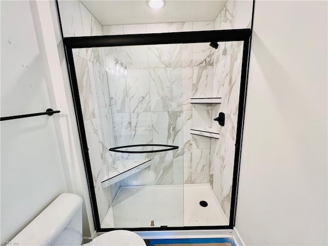 bathroom featuring walk in shower and toilet