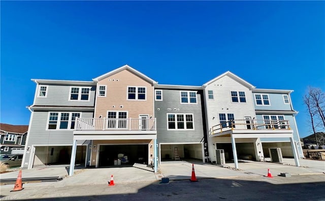 back of property featuring cooling unit and a balcony