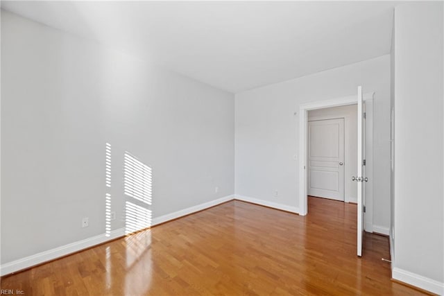 spare room with wood-type flooring