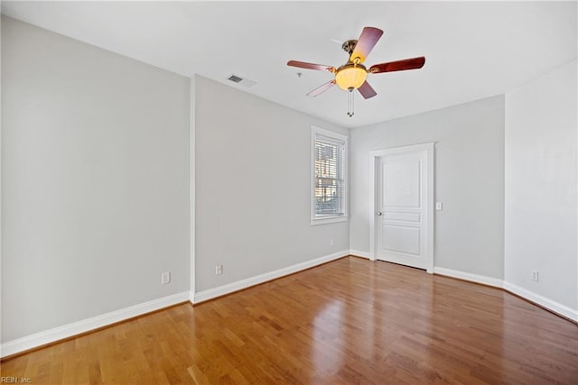 spare room featuring wood-type flooring and ceiling fan