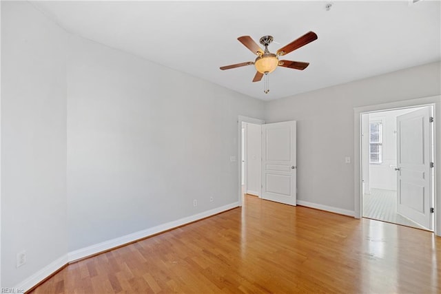 spare room with ceiling fan and light wood-type flooring