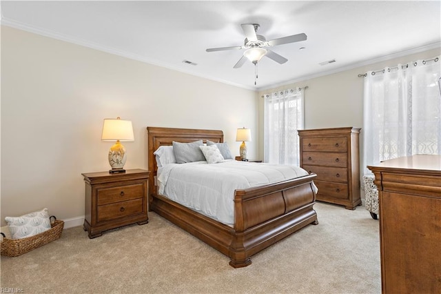 bedroom featuring ornamental molding, light colored carpet, and ceiling fan