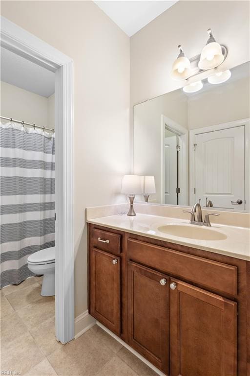 bathroom with tile patterned floors, toilet, and vanity