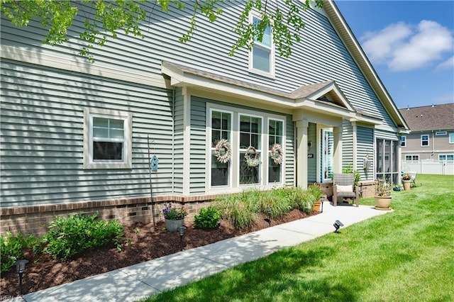 rear view of property featuring a yard