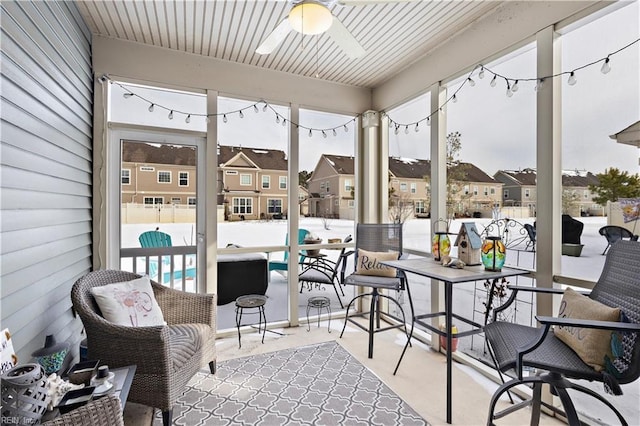 sunroom / solarium featuring ceiling fan