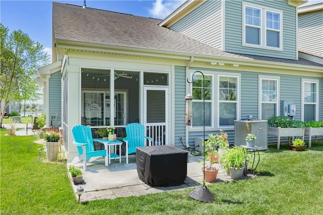 back of house featuring a lawn, central air condition unit, and a patio area