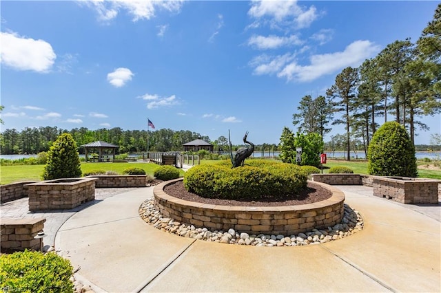 view of community with a gazebo and a water view