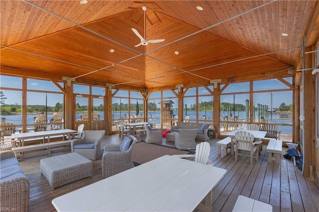 deck featuring a water view, ceiling fan, and outdoor lounge area