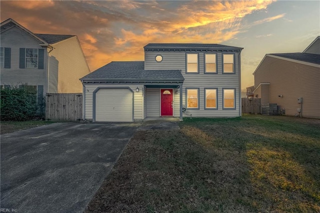 view of front of house featuring a garage and a yard