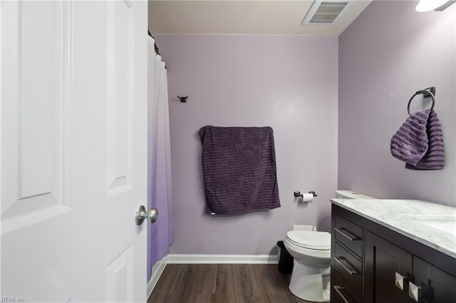 bathroom featuring vanity, hardwood / wood-style floors, and toilet