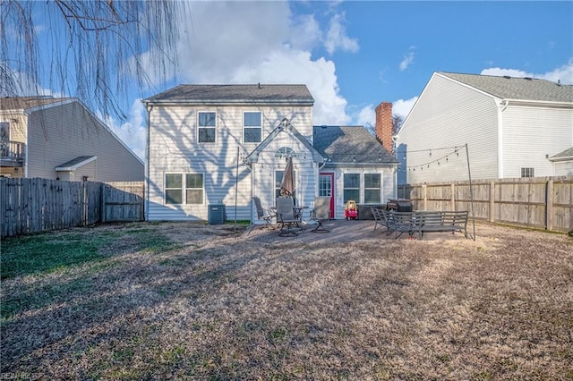 rear view of house with a lawn and a patio area