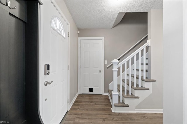 foyer featuring hardwood / wood-style floors and a textured ceiling