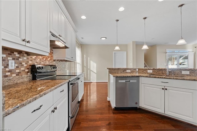 kitchen featuring stainless steel appliances, white cabinets, and decorative light fixtures