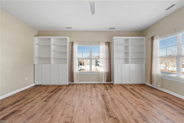 unfurnished bedroom with ceiling fan and light hardwood / wood-style floors