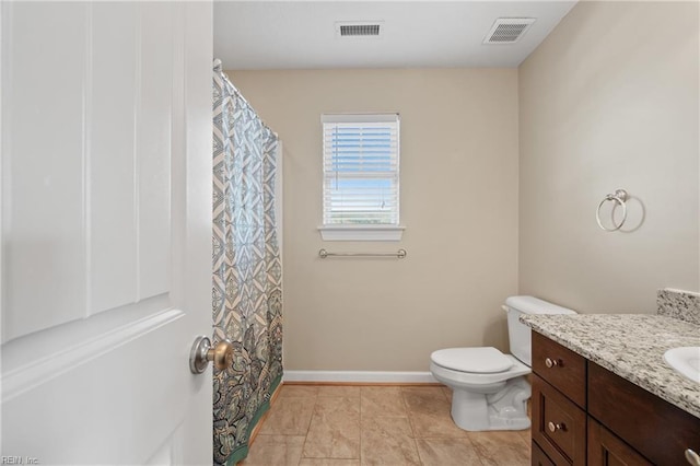 bathroom with vanity, tile patterned floors, and toilet