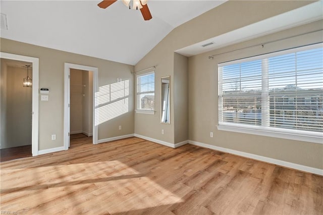 spare room with lofted ceiling, light hardwood / wood-style flooring, and ceiling fan