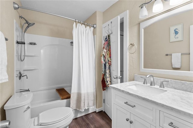 full bathroom with hardwood / wood-style flooring, shower / bath combo, vanity, and toilet