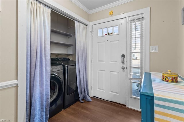 washroom with ornamental molding, dark wood-type flooring, and washing machine and clothes dryer