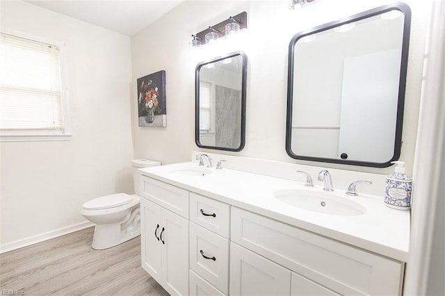 bathroom featuring vanity, hardwood / wood-style floors, and toilet