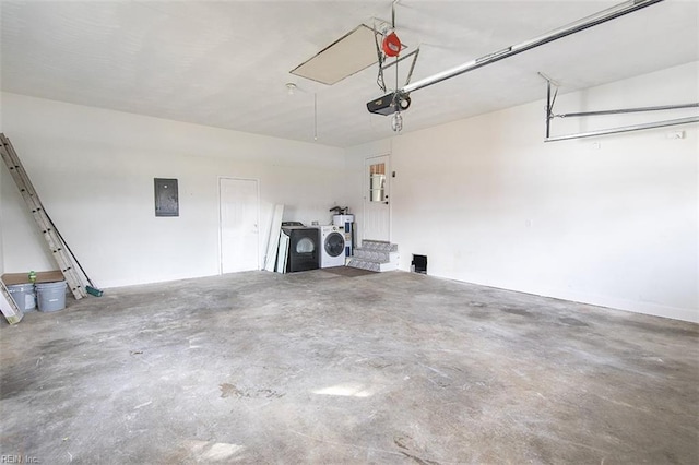 garage with a garage door opener, electric panel, and washing machine and dryer