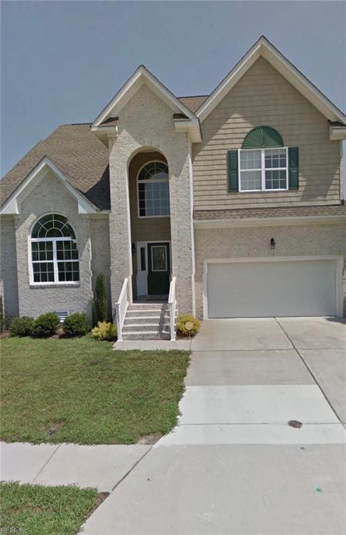 view of front of property featuring a garage and a front yard