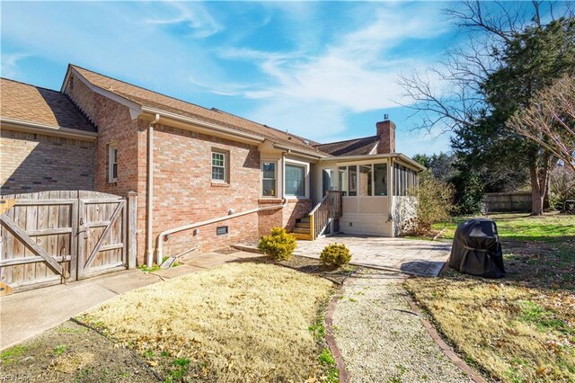 back of house with a patio and a sunroom