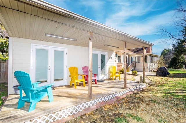 back of property with a wooden deck and french doors