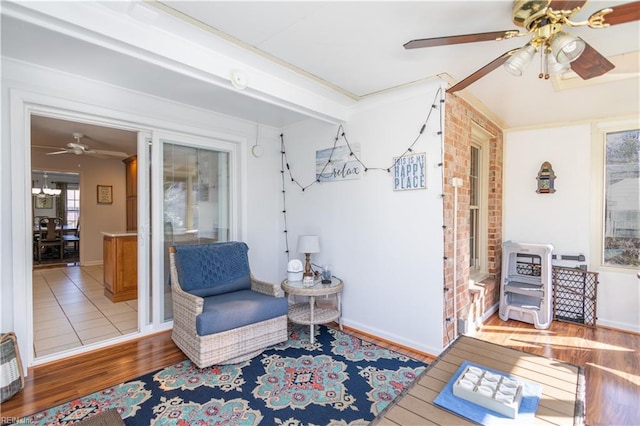 living area featuring hardwood / wood-style floors and ceiling fan