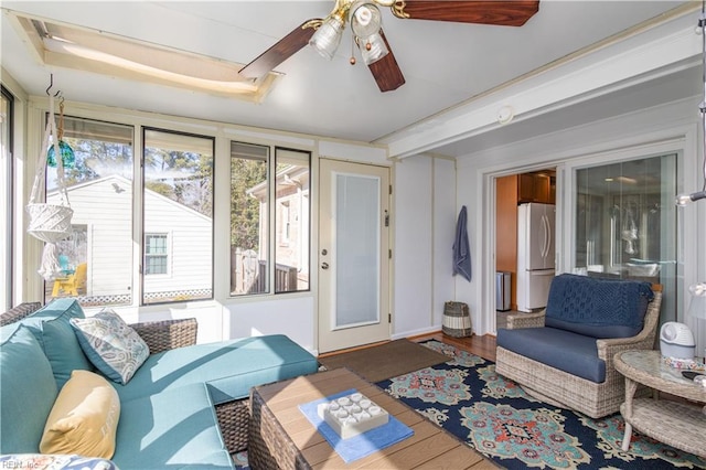 living room featuring wood-type flooring and ceiling fan