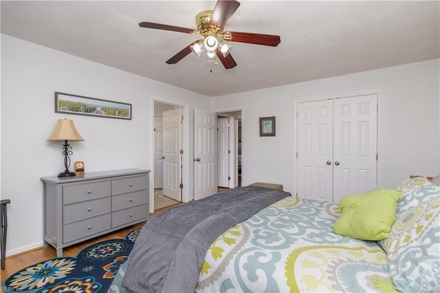 bedroom featuring ceiling fan, a closet, and light wood-type flooring