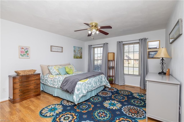 bedroom with ceiling fan and light hardwood / wood-style flooring