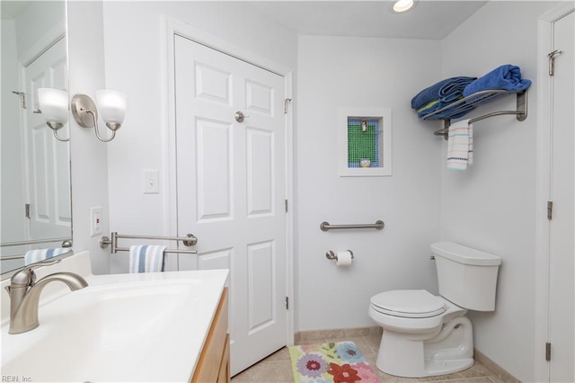 bathroom with vanity, toilet, and tile patterned flooring