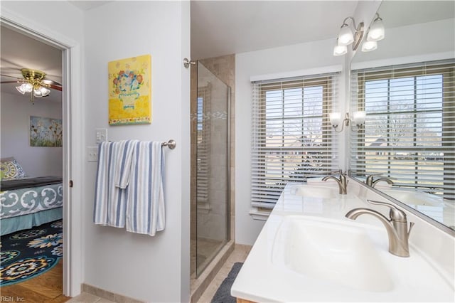 bathroom featuring vanity, ceiling fan, and walk in shower