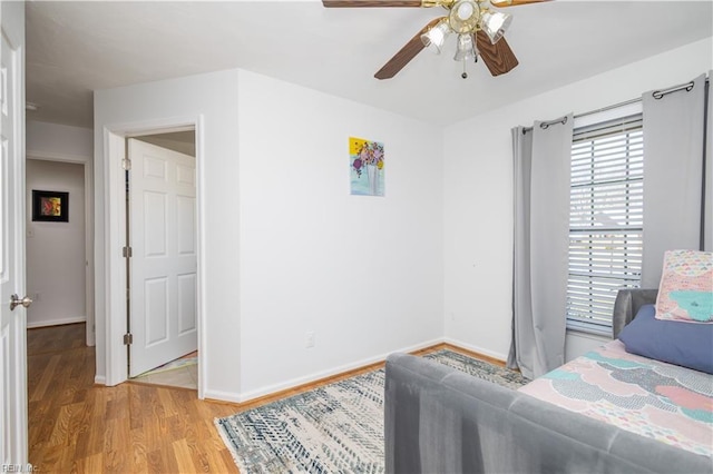 bedroom with hardwood / wood-style floors and ceiling fan