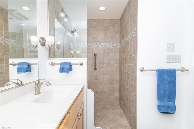 bathroom with a shower with door and vanity