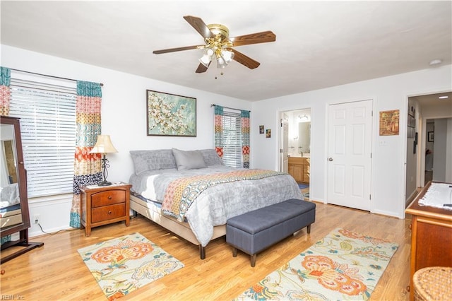 bedroom featuring connected bathroom, ceiling fan, and light hardwood / wood-style flooring