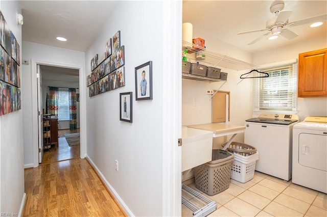 clothes washing area with ceiling fan, plenty of natural light, cabinets, and washing machine and clothes dryer