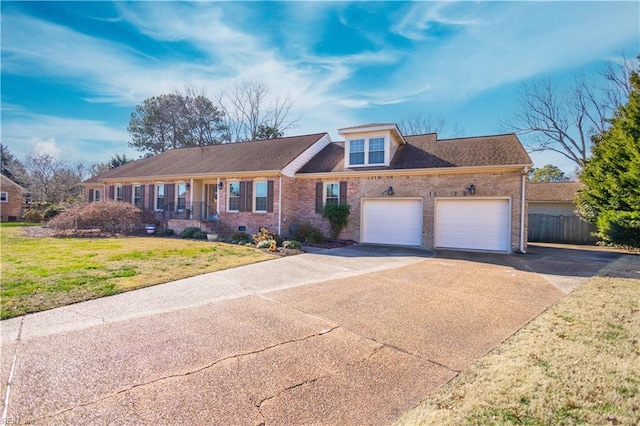 view of front of home with a garage and a front lawn