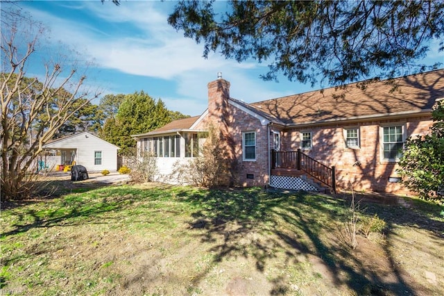 rear view of house featuring a lawn